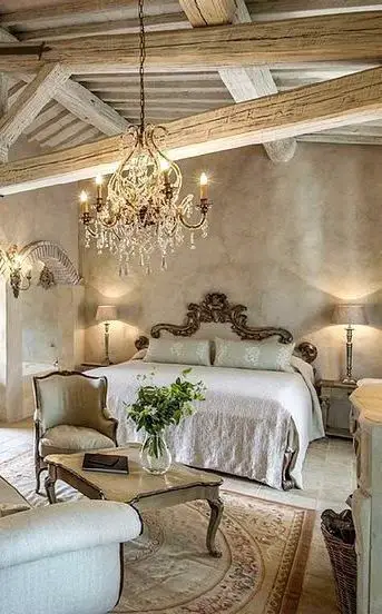stunning rustic master bedroom lighting idea - rustic mixed with a shabby chic design idea.  Love the pallet/ exposed wood beams and vaulted ceiling...and LOVE the bedroom chandelier over the bed.