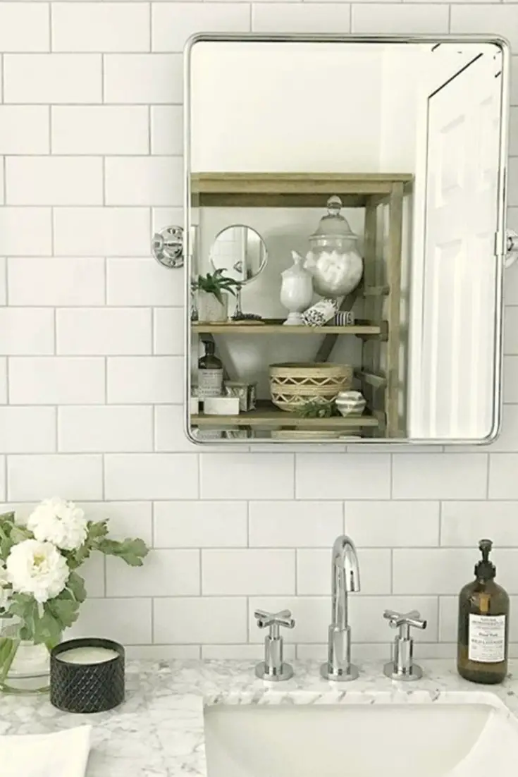 Subway tile bathroom wall idea - love the look of this bathroom makeover project after using subway tile on the wall behind the mirrors.