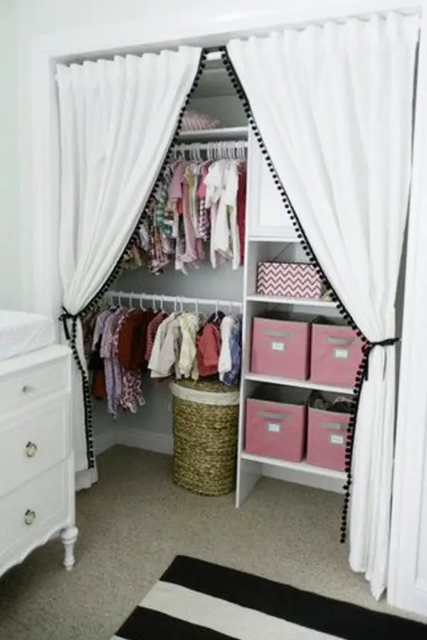 This baby room closet idea is one of my favorites.  I love the idea of making a nursery closet bigger and more usable by removing the closet door(s), but adding this curtain is just brilliant.  Very simple DIY hack that will fit any budget.