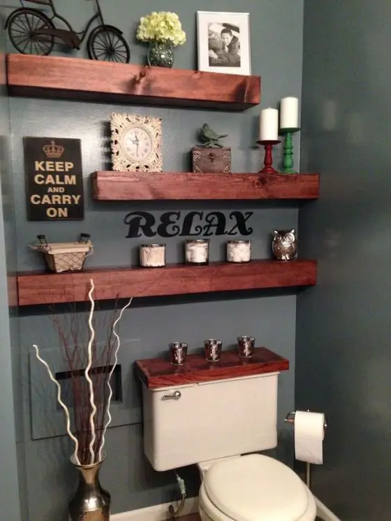 Beautiful DIY bathroom shelves idea over the toilet. Love the gray wall paint to set it all off.