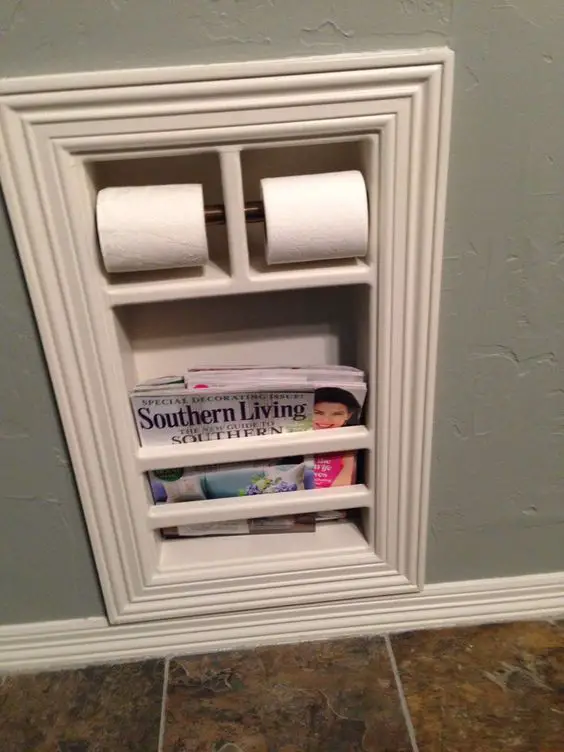 bathroom storage ideas for organizing all the small spaces in your tiny bathroom - built in toilet paper holder and magazine holder - bathroom organization ideas