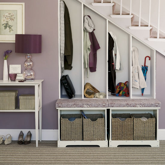 Cubby storage ideas under the stairs in foyer with bench and baskets.  great use of extra small space for more storage and organization