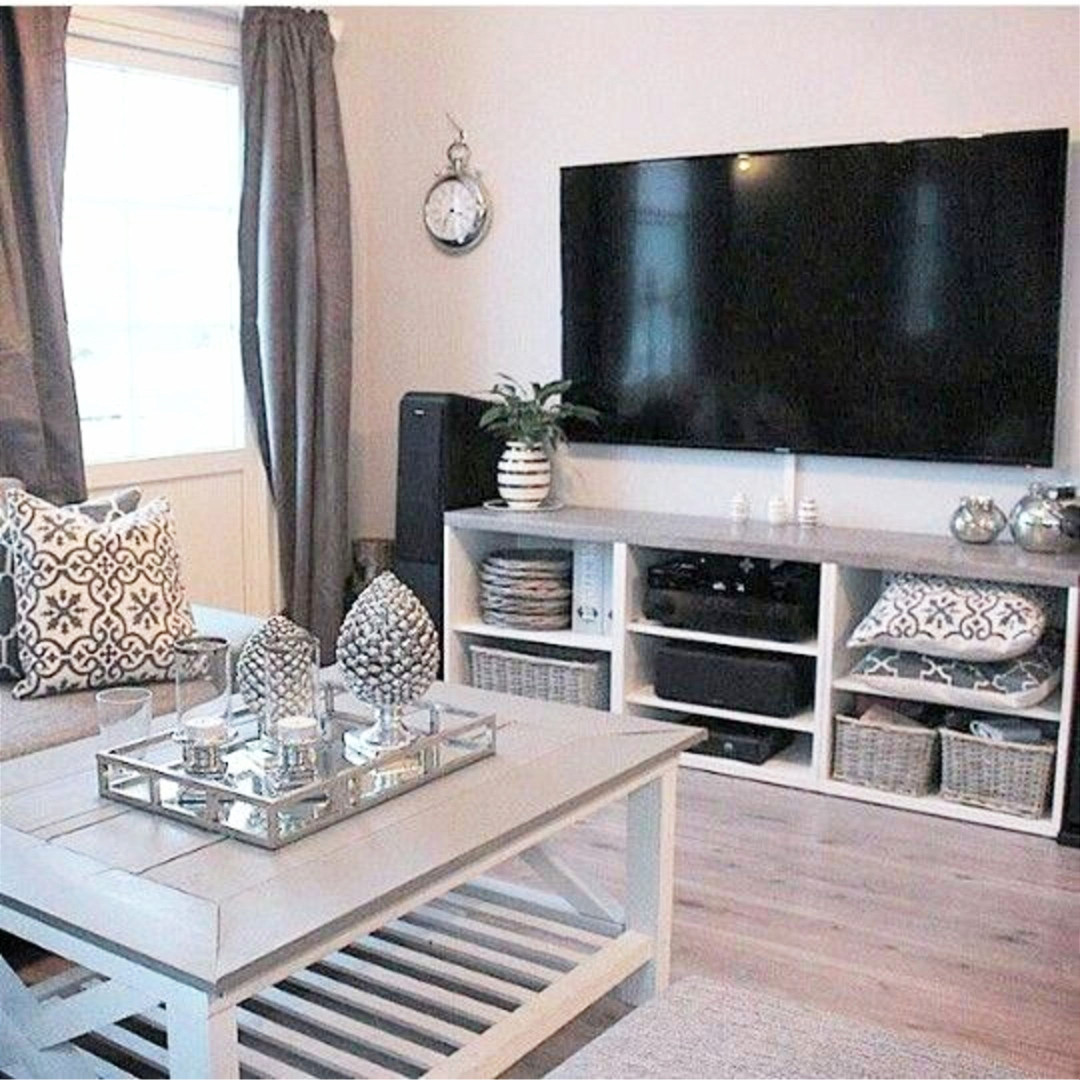 Neutral living room decorating idea - a touch of farmhouse style - love the entertainment center with the baskets