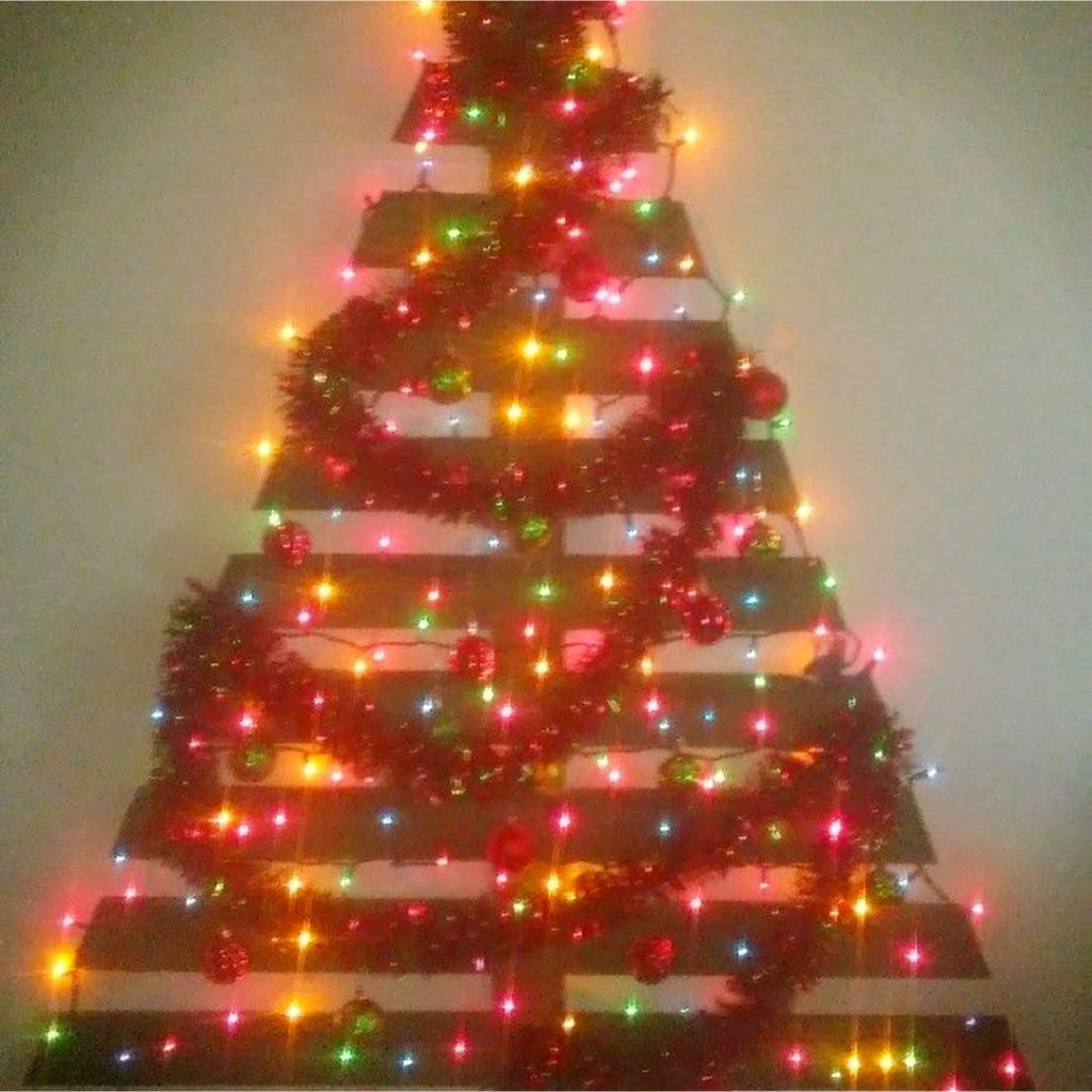 DIY Pallet Christmas Tree Ideas - We Tried It!  Make a Christmas tree from old pallets (tutorial video too)... painted ideas, with lights, decorated, indoors and outdoors ideas for front porches at Xmas.