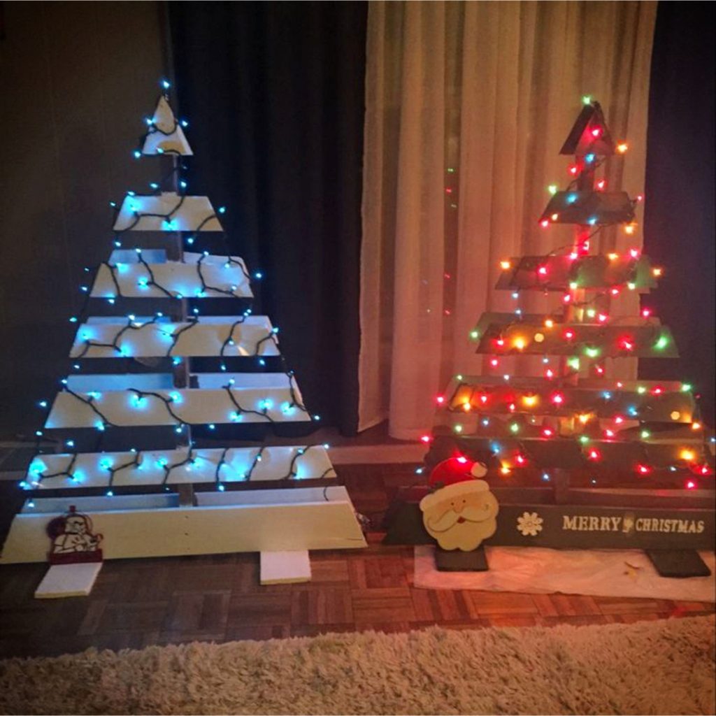 DIY Pallet Christmas Tree Ideas - We Tried It!  Make a Christmas tree from old pallets (tutorial video too)... painted ideas, with lights, decorated, indoors and outdoors ideas for front porches at Xmas.