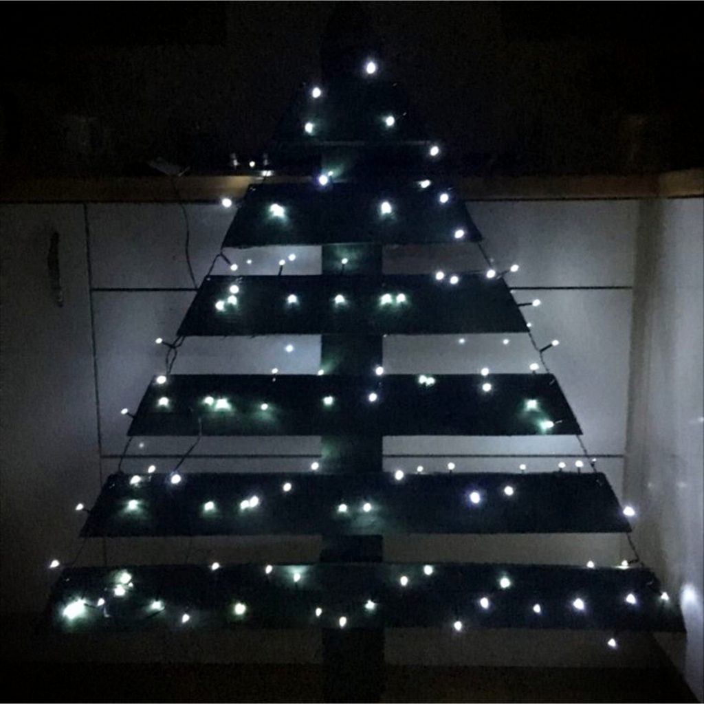 DIY Pallet Christmas Tree Ideas - We Tried It!  Make a Christmas tree from old pallets (tutorial video too)... painted ideas, with lights, decorated, indoors and outdoors ideas for front porches at Xmas.