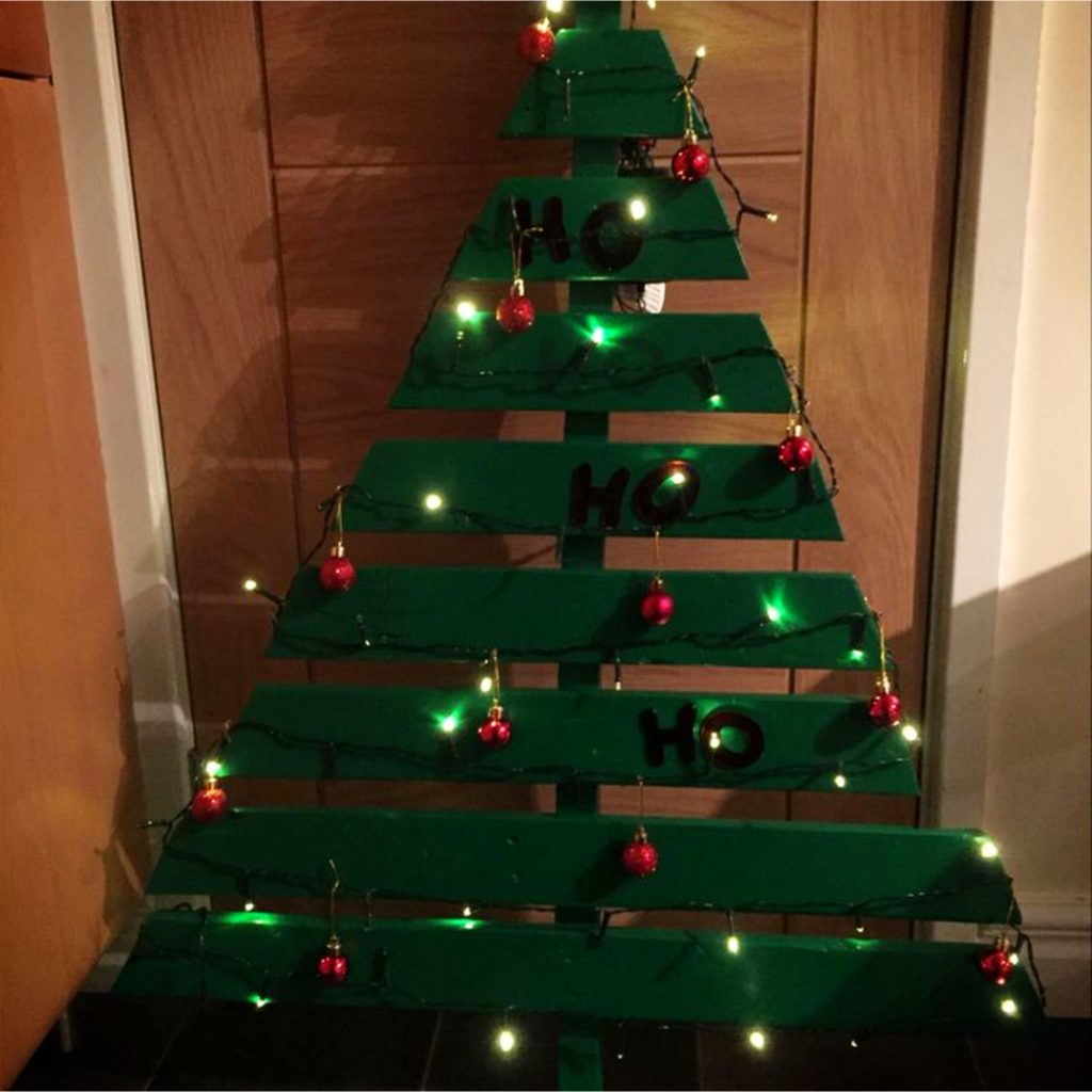 DIY Pallet Christmas Tree Ideas - We Tried It!  Make a Christmas tree from old pallets (tutorial video too)... painted ideas, with lights, decorated, indoors and outdoors ideas for front porches at Xmas.