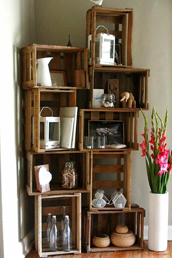 Stacked wooden crates used as a corner bookshelf or shelving unit