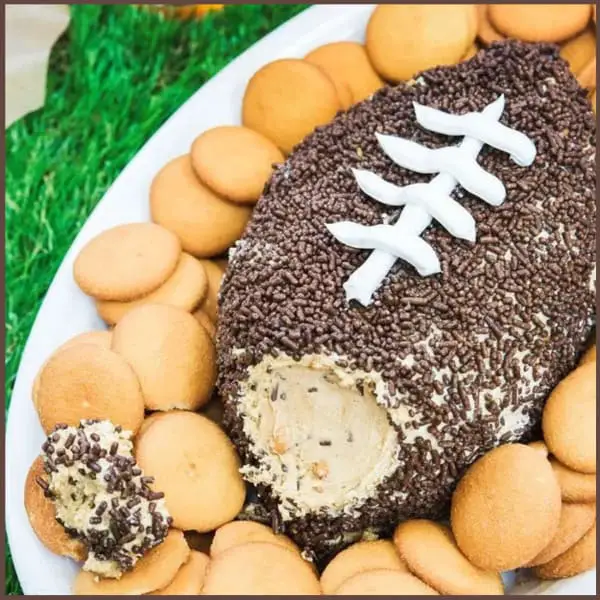  Football Party Food Appetizers and Fingerfood ideas for a crowd!  This crowd pleasing no cook / no bake football party peanut butter cold dessert dip is a real crowd pleaser & easy snack - perfect for your SuperBowl party crowd, tailgating or family gathering this holiday - Kids LOVE it. See more easy appetizer ideas and make ahead fingerfood recipes here.