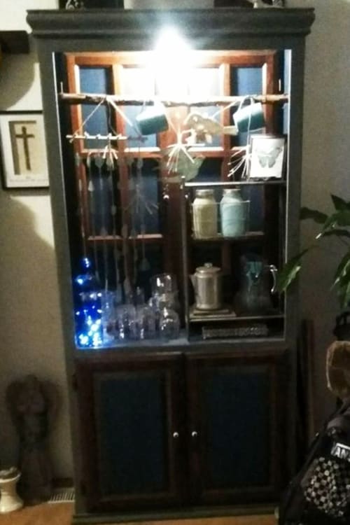 Converting a china cabinet into a beautiful keepsake - this old, run down hutch belonged to her mother in law and she converted it into a keepsake treasure!