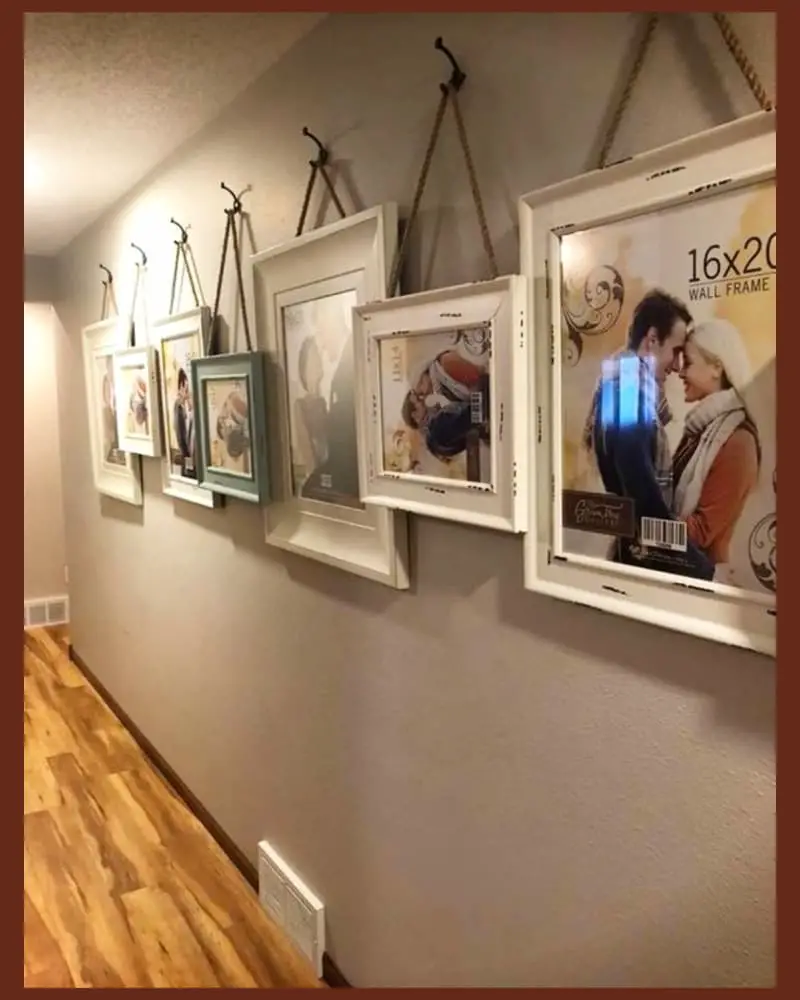 family picture wall ideas for hallway - hanging family pictures in large frames down narrow hallway off living room