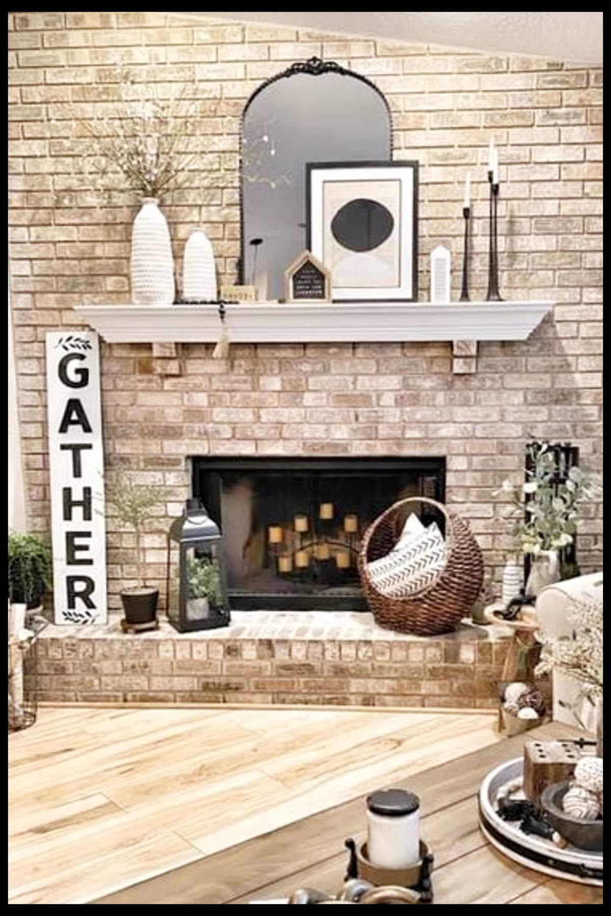farmhouse fireplace ideas with floating mantel shelf, large gather wood sign, baskets, mirror and other Joanna Gaines style decor